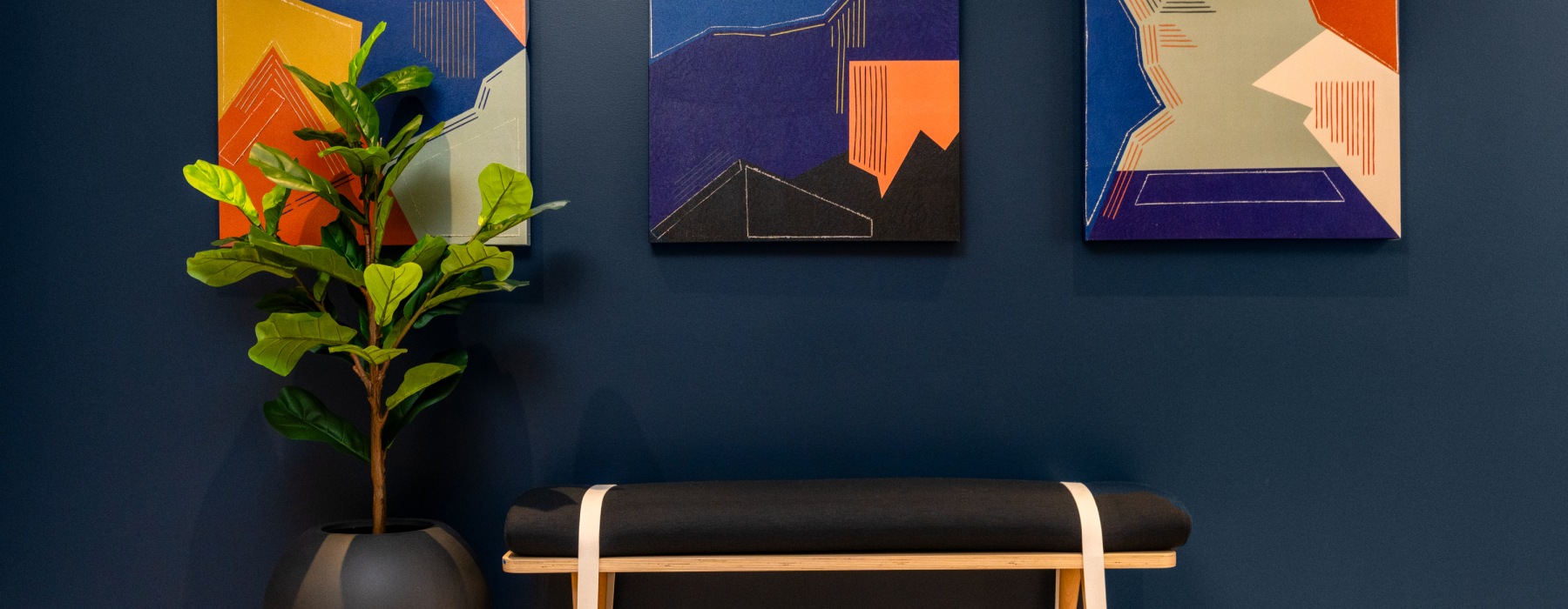 Lobby area setting with bench and artwork