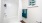 a white tiled shower and blue towels
