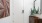 an entryway with a plant and a mirror